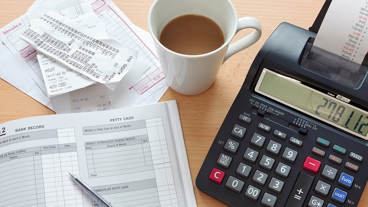 Bookkeeping sales ledger, invoices and a print calculator