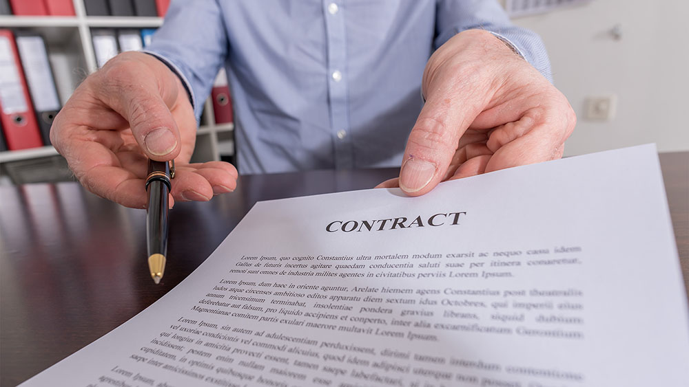 man holding out contract to sign